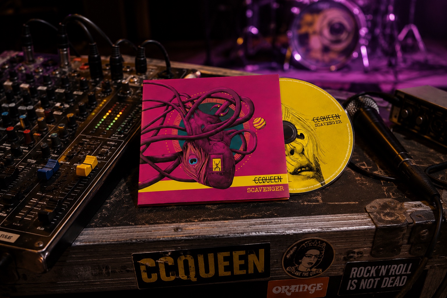 Le CD Scavenger posé sur une console de mixage, batterie sous les lumières violettes en arrière-plan